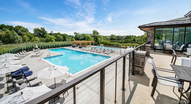 2965 Aughton Rd, Ann Arbor, MI 48105 - community pool featuring a pergola, an outdoor living space, and view of wooded area