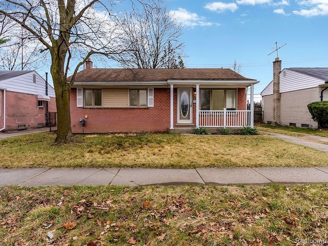33855 Cherry Hill Rd, Westland, MI 48186 - view of front of home with covered porch, brick siding, a chimney, and a front lawn