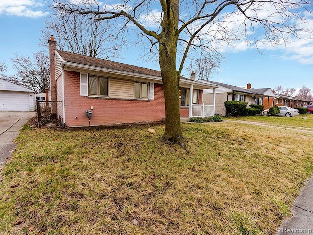 33855 Cherry Hill Rd, Westland, MI 48186 - ranch-style home featuring brick siding, a chimney, a front lawn, an outdoor structure, and a porch