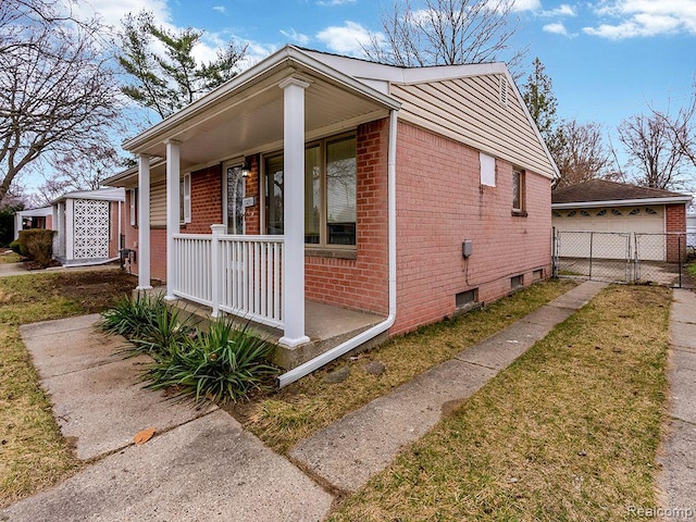 33855 Cherry Hill Rd, Westland, MI 48186 - view of front facade with brick siding, covered porch, an outbuilding, and a detached garage