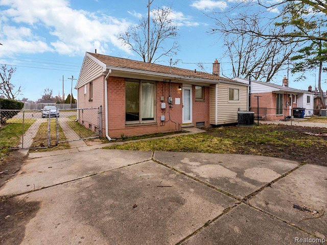 33855 Cherry Hill Rd, Westland, MI 48186 - view of front facade with brick siding, concrete driveway, a chimney, and a gate