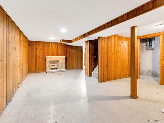 33855 Cherry Hill Rd, Westland, MI 48186 - unfurnished living room featuring wood walls, stairs, electric panel, tile patterned floors, and a brick fireplace