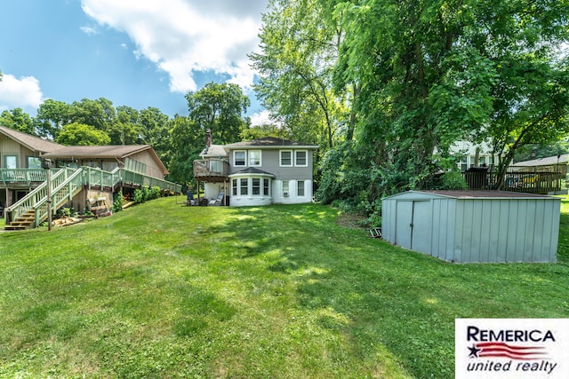 9420 Van Antwerp Rd, Brighton, MI 48116 - view of grassy yard with a deck, stairs, and a shed