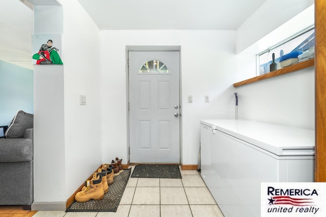 9420 Van Antwerp Rd, Brighton, MI 48116 - washroom with washing machine and clothes dryer and light tile patterned floors
