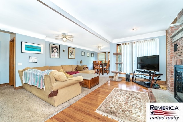 9420 Van Antwerp Rd, Brighton, MI 48116 - living room featuring a brick fireplace, a ceiling fan, and wood finished floors