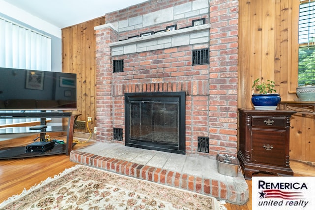 9420 Van Antwerp Rd, Brighton, MI 48116 - living room with wood finished floors, a fireplace, and wood walls