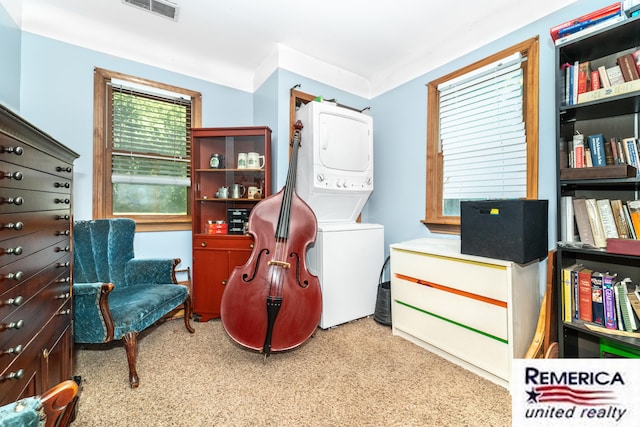9420 Van Antwerp Rd, Brighton, MI 48116 - living area featuring stacked washer / drying machine and carpet flooring
