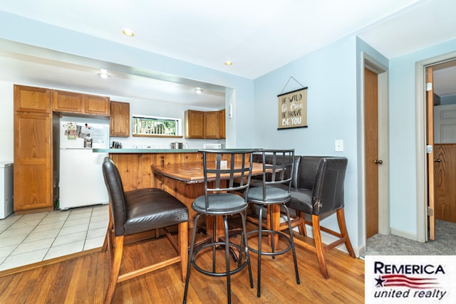 9420 Van Antwerp Rd, Brighton, MI 48116 - dining area with bar area, light wood finished floors, and recessed lighting