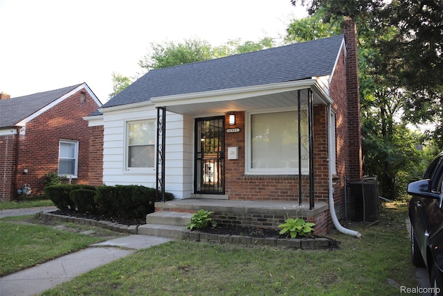 18951 Edinborough, Detroit, MI 48219 - bungalow with a chimney, a front lawn, brick siding, and roof with shingles