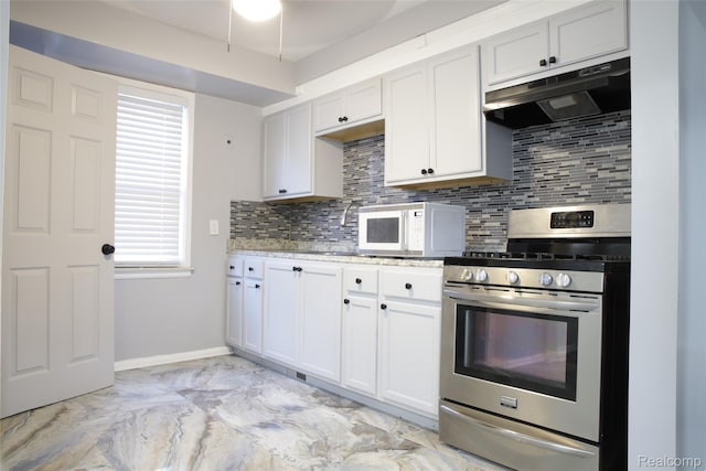 18951 Edinborough, Detroit, MI 48219 - kitchen featuring stainless steel gas range, under cabinet range hood, white microwave, light marble finish floors, and decorative backsplash