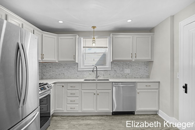 1215 Emerald Ave NE, Grand Rapids, MI 49505 - kitchen with stainless steel appliances, light wood-type flooring, white cabinetry, and recessed lighting