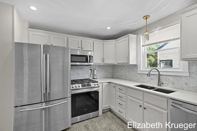 1215 Emerald Ave NE, Grand Rapids, MI 49505 - kitchen featuring appliances with stainless steel finishes, white cabinetry, backsplash, and recessed lighting