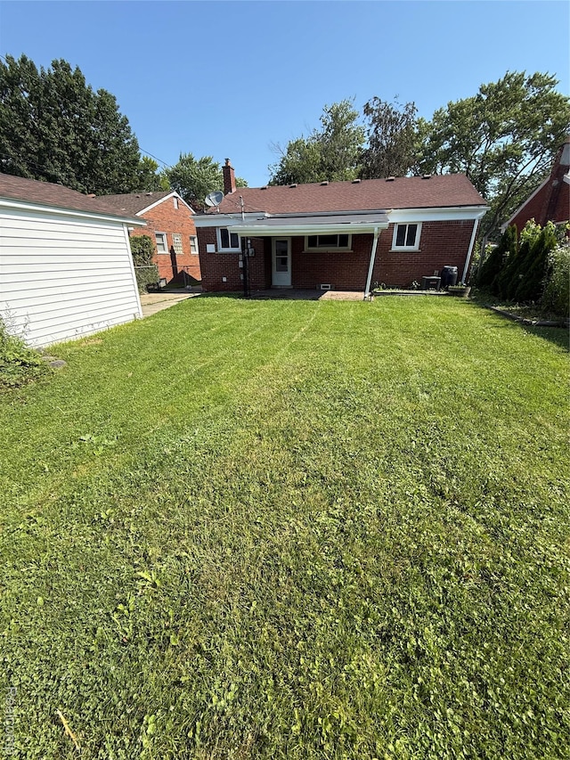 19612 Gaukler St, Saint Clair Shores, MI 48080 - back of property featuring a yard, a chimney, and brick siding