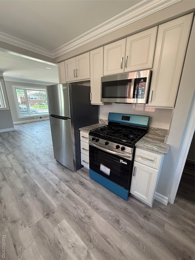 19612 Gaukler St, Saint Clair Shores, MI 48080 - kitchen featuring stainless steel appliances, ornamental molding, light wood-style flooring, white cabinetry, and light stone countertops