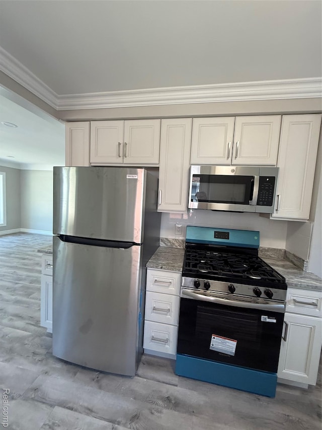 19612 Gaukler St, Saint Clair Shores, MI 48080 - kitchen with stainless steel appliances, ornamental molding, light stone countertops, white cabinetry, and light wood-type flooring
