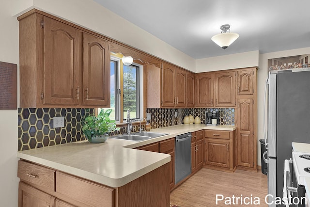 4707 Cannonsburg Rd NE, Belmont, MI 49306 - kitchen with stainless steel dishwasher, light wood-type flooring, light countertops, and white range
