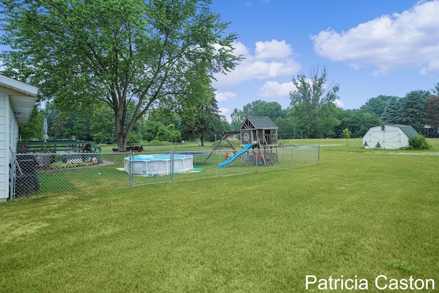 4707 Cannonsburg Rd NE, Belmont, MI 49306 - view of yard featuring a playground, a storage unit, and view of scattered trees