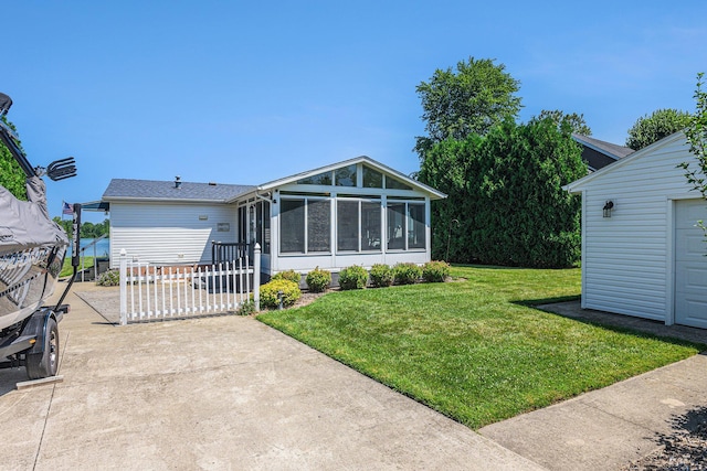432 Spaulding Dr, Coldwater, MI 49036 - back of property featuring a sunroom and a lawn