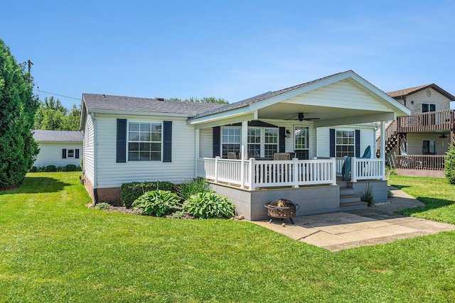 432 Spaulding Dr, Coldwater, MI 49036 - view of front facade featuring a front yard, a ceiling fan, a shingled roof, and a patio area