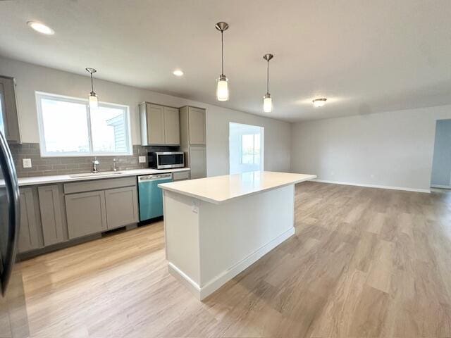 LOT100 Wren Dr SE, Caledonia, MI 49316 - kitchen featuring dishwashing machine, gray cabinets, stainless steel microwave, light countertops, and decorative backsplash
