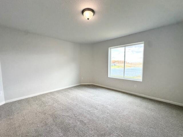 LOT100 Wren Dr SE, Caledonia, MI 49316 - spare room featuring carpet flooring and baseboards