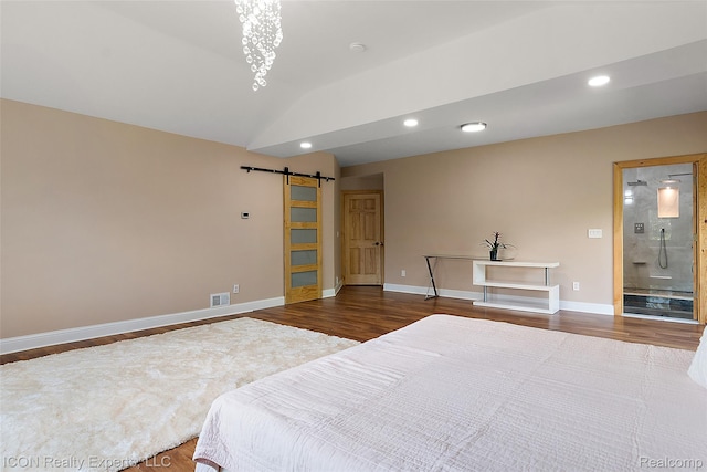 6727 Napier Rd, Plymouth, MI 48170 - bedroom with a barn door, wood finished floors, vaulted ceiling, recessed lighting, and connected bathroom