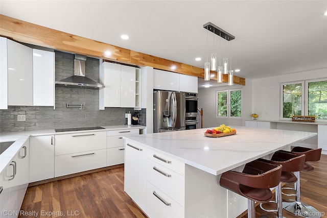 6727 Napier Rd, Plymouth, MI 48170 - kitchen featuring wall chimney exhaust hood, modern cabinets, appliances with stainless steel finishes, recessed lighting, and a kitchen island