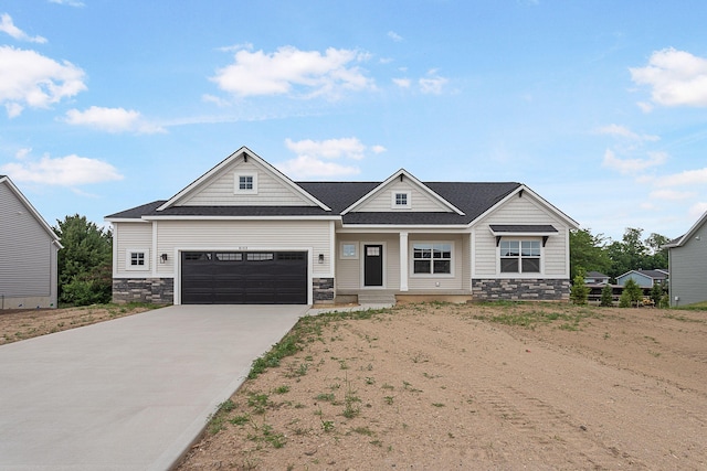 6153 Lake Wind Ave, Holland, MI 49423 - craftsman-style house with concrete driveway, stone siding, an attached garage, and a shingled roof