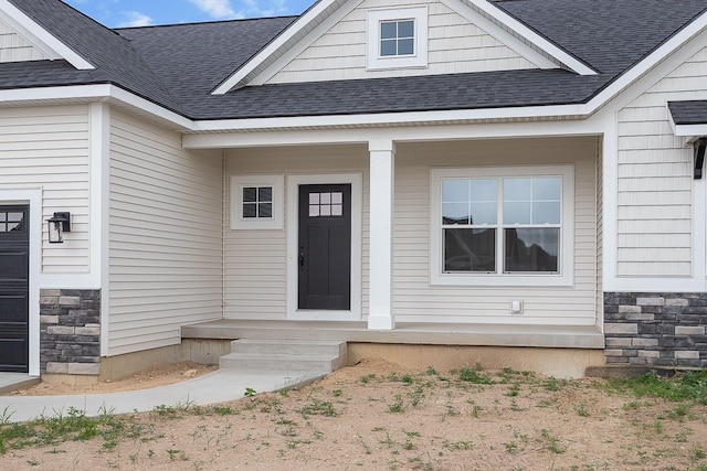 6153 Lake Wind Ave, Holland, MI 49423 - property entrance with stone siding and a shingled roof