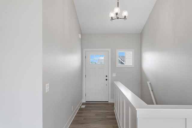 6153 Lake Wind Ave, Holland, MI 49423 - doorway to outside featuring a chandelier and dark wood-style floors