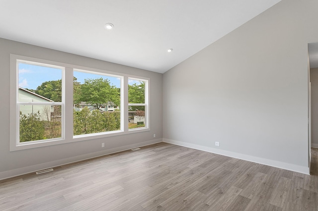 6153 Lake Wind Ave, Holland, MI 49423 - spare room with light wood-type flooring, vaulted ceiling, and recessed lighting