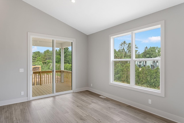6153 Lake Wind Ave, Holland, MI 49423 - unfurnished room featuring wood finished floors, vaulted ceiling, and recessed lighting