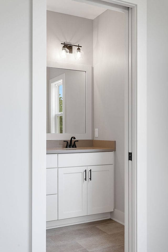 6153 Lake Wind Ave, Holland, MI 49423 - bathroom featuring vanity and baseboards