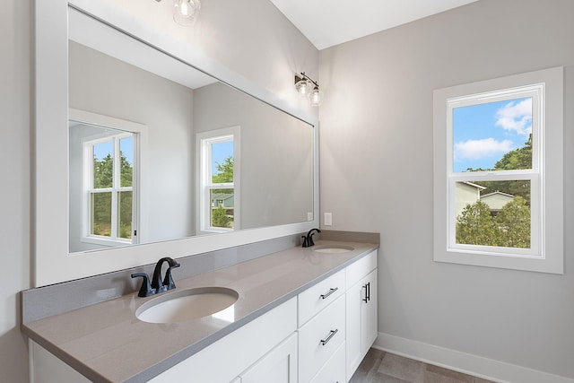 6153 Lake Wind Ave, Holland, MI 49423 - bathroom featuring double vanity and baseboards