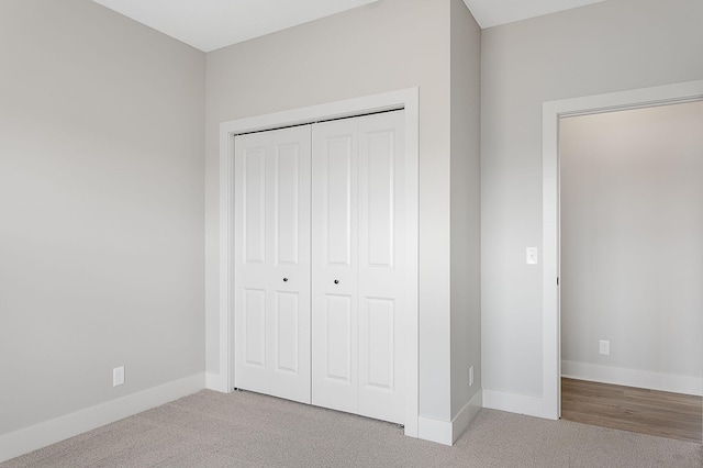 6153 Lake Wind Ave, Holland, MI 49423 - unfurnished bedroom featuring carpet and a closet