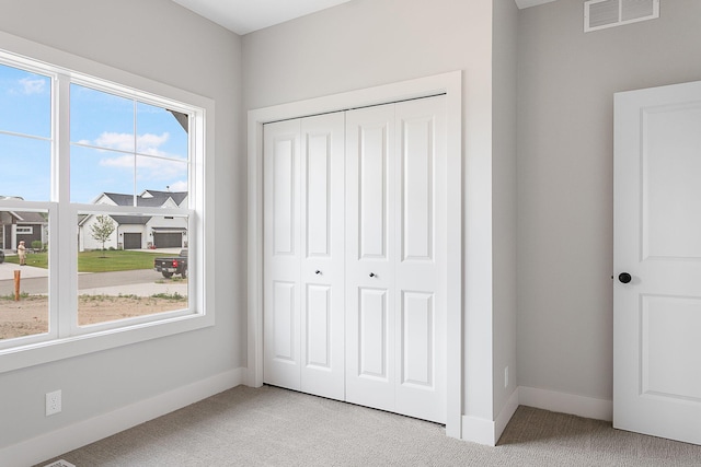6153 Lake Wind Ave, Holland, MI 49423 - unfurnished bedroom with light carpet and a closet