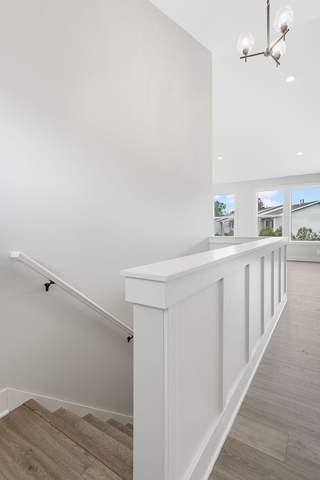 6153 Lake Wind Ave, Holland, MI 49423 - stairway featuring a chandelier, wood finished floors, and recessed lighting