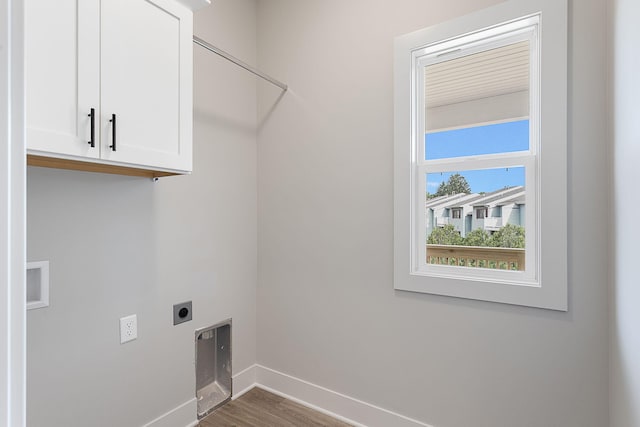 6153 Lake Wind Ave, Holland, MI 49423 - washroom with electric dryer hookup, cabinet space, and wood finished floors