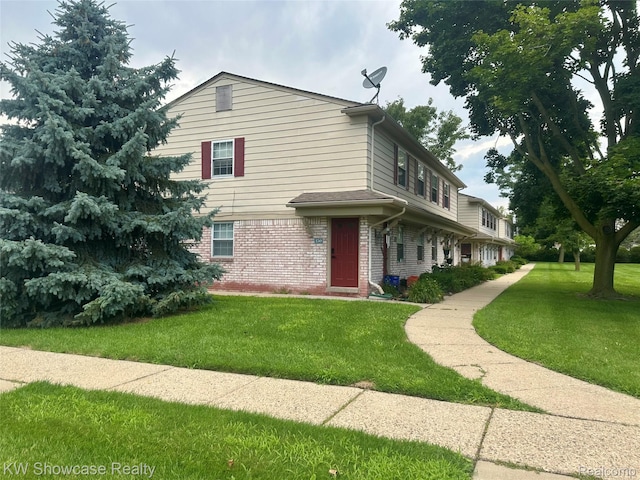 150 Princeton Dr Unit 22, South Lyon, MI 48178 - view of front facade featuring a front yard and brick siding