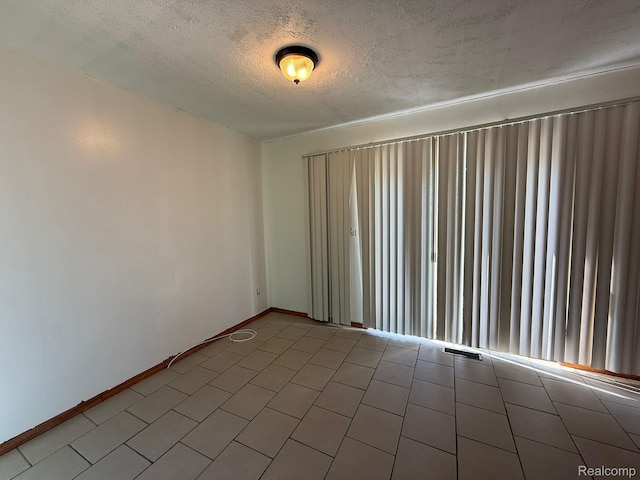 13420 Couwlier Ave, Warren, MI 48089 - unfurnished room featuring a textured ceiling and tile patterned floors