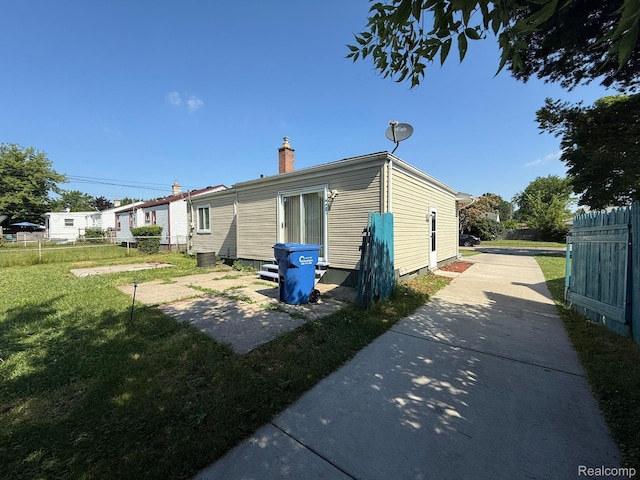 13420 Couwlier Ave, Warren, MI 48089 - back of property featuring a chimney and concrete driveway