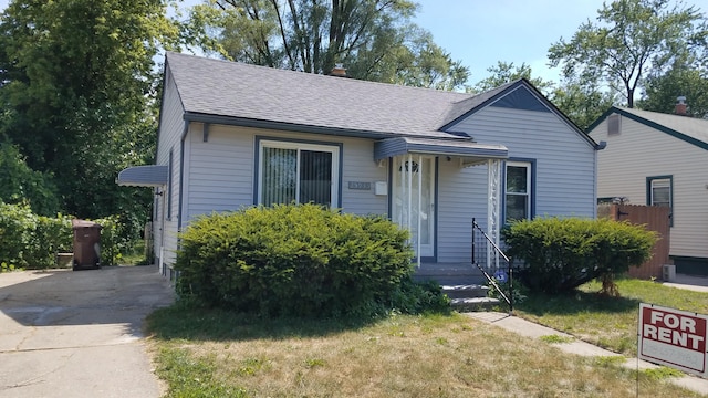 25933 Norfolk St, Inkster, MI 48141 - bungalow-style home with roof with shingles, driveway, and a chimney