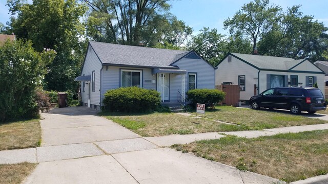25933 Norfolk St, Inkster, MI 48141 - bungalow featuring roof with shingles, a front lawn, and driveway