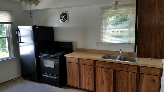 25933 Norfolk St, Inkster, MI 48141 - kitchen with black appliances, light countertops, and brown cabinetry