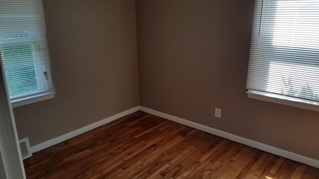 25933 Norfolk St, Inkster, MI 48141 - empty room featuring dark wood-type flooring and plenty of natural light