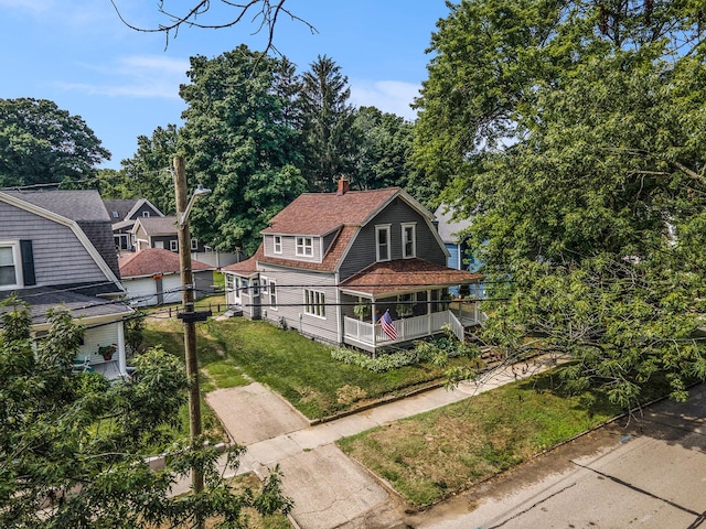 722 Conger St, South Haven, MI 49090 - shingle-style home featuring a gambrel roof, roof with shingles, a front lawn, and a chimney