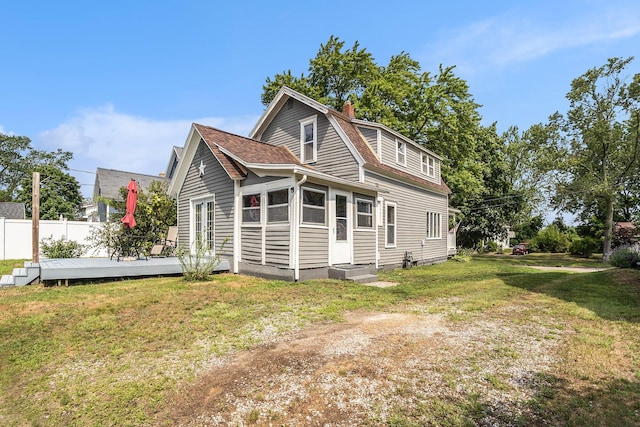 722 Conger St, South Haven, MI 49090 - view of home's exterior featuring a wooden deck, a chimney, and roof with shingles