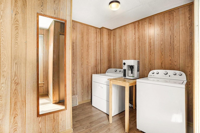 722 Conger St, South Haven, MI 49090 - laundry area featuring washer and dryer, wooden walls, and wood finished floors