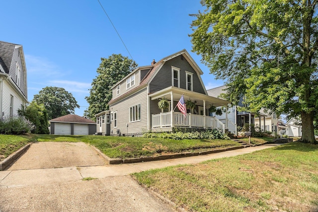 722 Conger St, South Haven, MI 49090 - dutch colonial featuring covered porch, an outbuilding, a gambrel roof, a detached garage, and a front lawn
