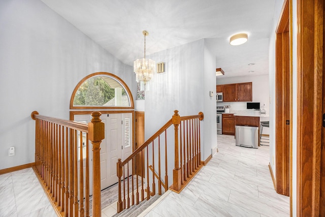 1527 Wiersma Dr, Zeeland, MI 49464 - hall with an upstairs landing, a chandelier, and light marble finish floors